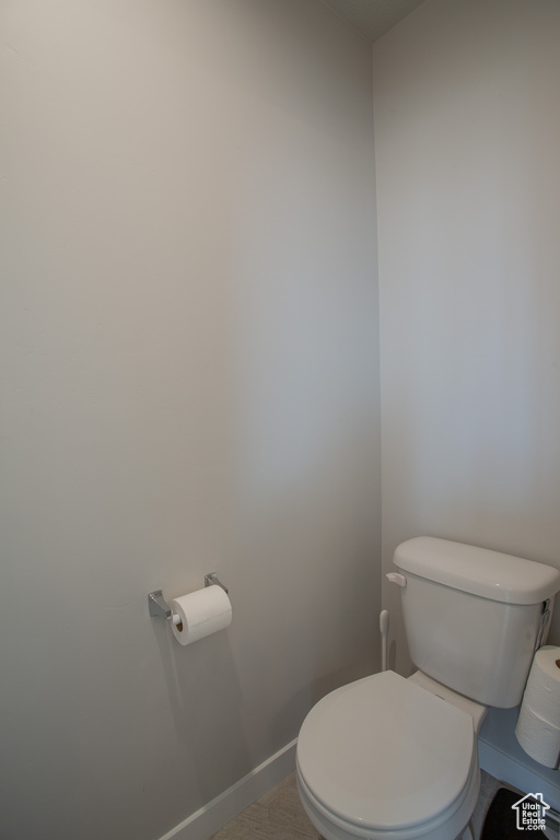 Bathroom featuring toilet and baseboards