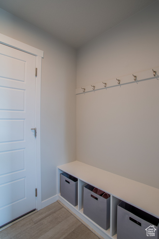 Mudroom with light wood-type flooring and baseboards