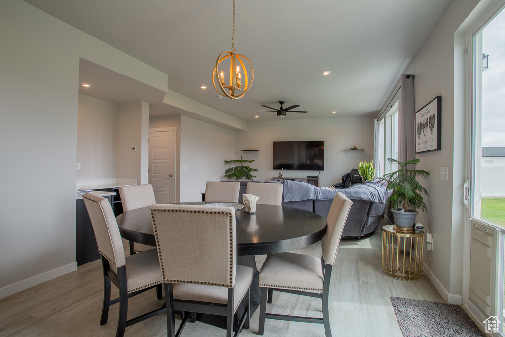 Dining room with a chandelier, light wood-style flooring, healthy amount of natural light, recessed lighting, and ceiling fan