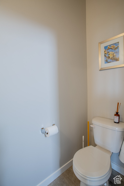 Bathroom with toilet and baseboards