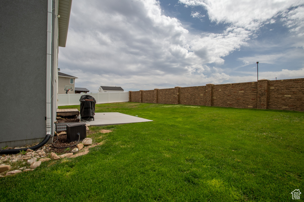Fenced backyard with a patio area