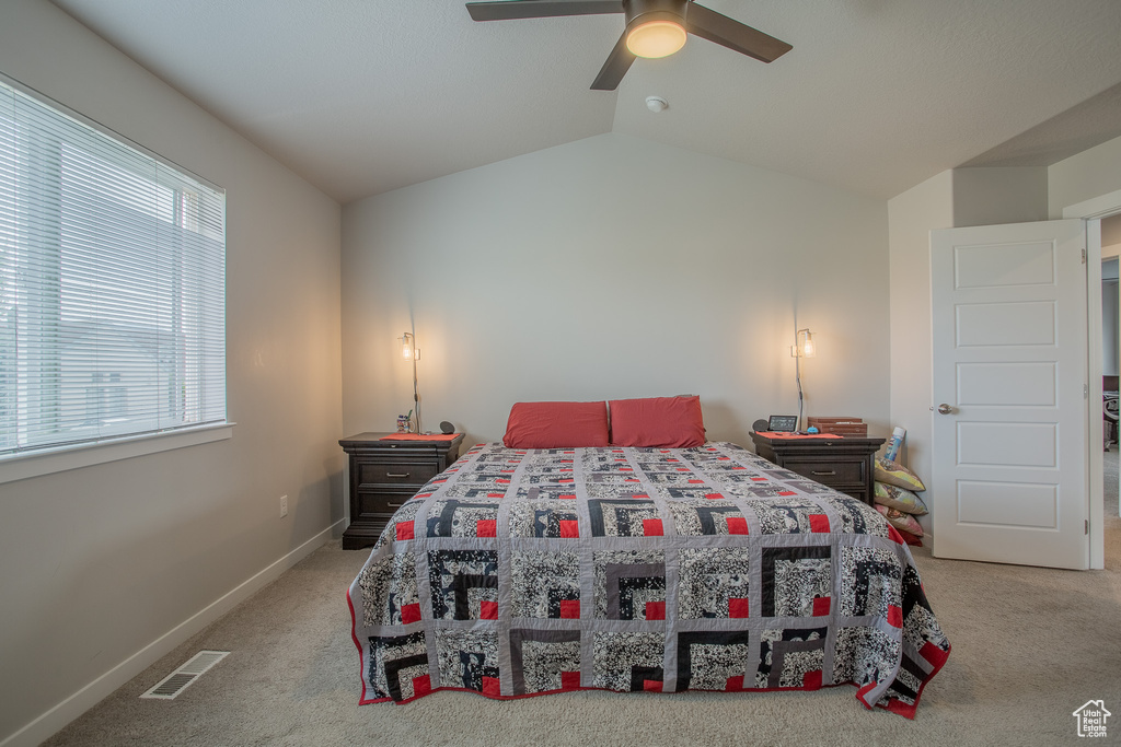 Bedroom with carpet floors, lofted ceiling, and ceiling fan