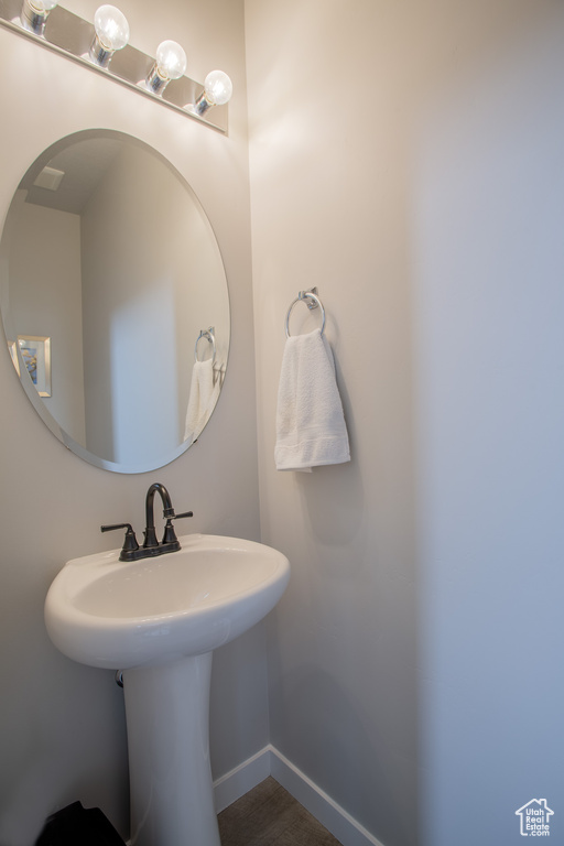 Bathroom featuring a sink and baseboards