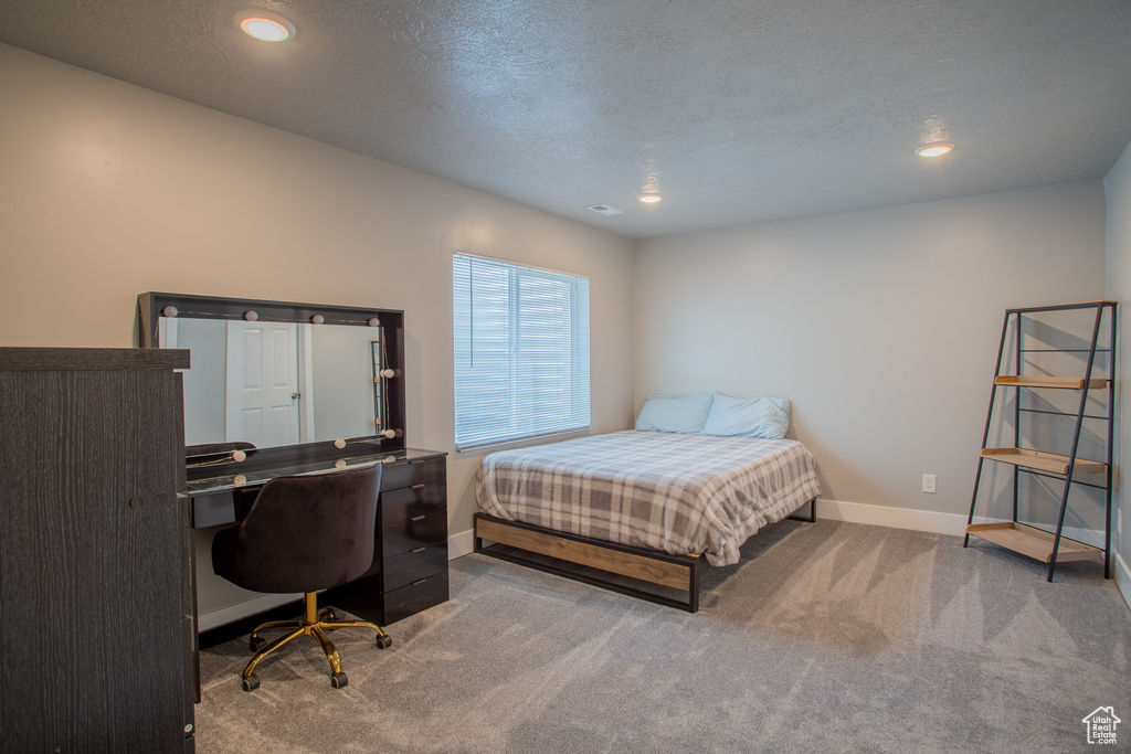 Bedroom with carpet floors, an office area, recessed lighting, and a textured ceiling