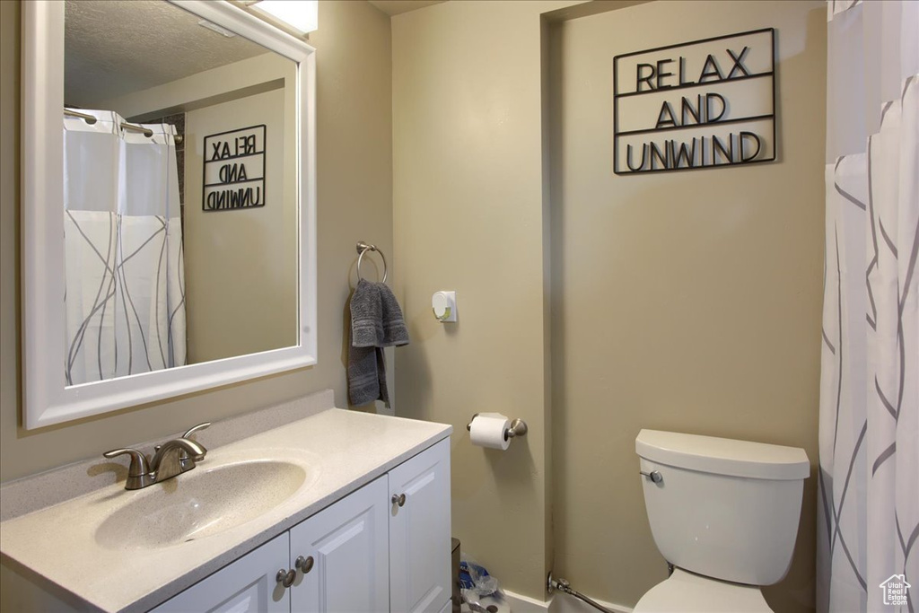 Bathroom featuring vanity and a textured ceiling