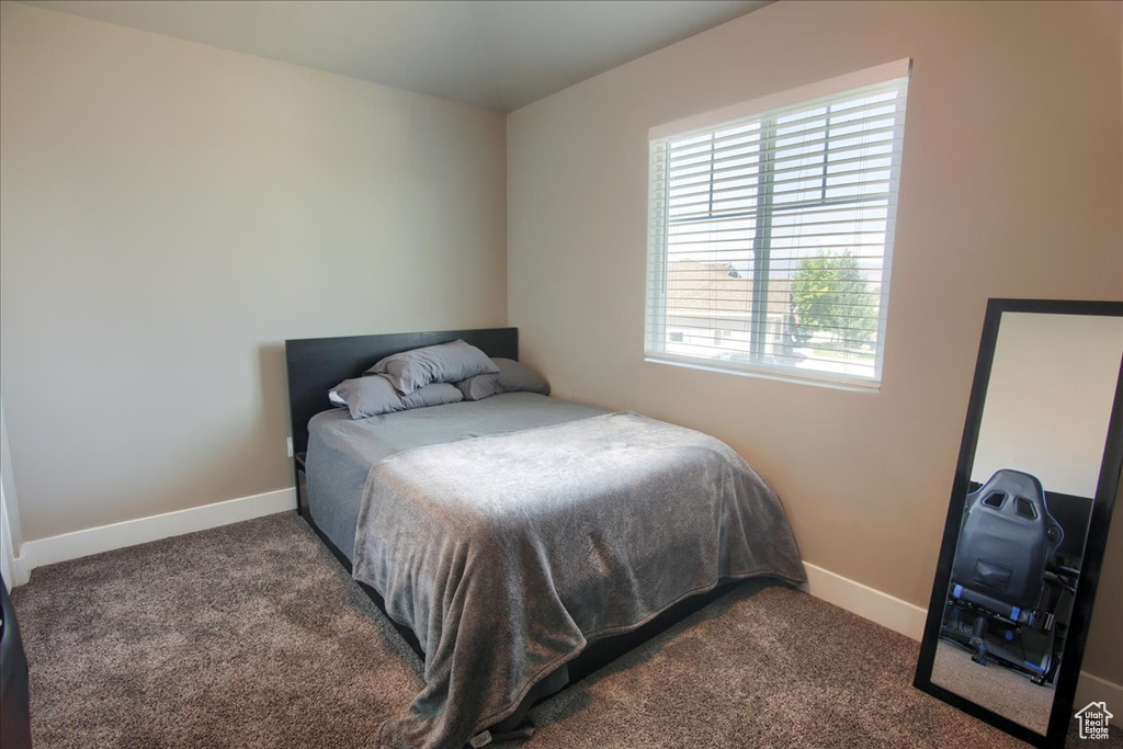 Carpeted bedroom with baseboards