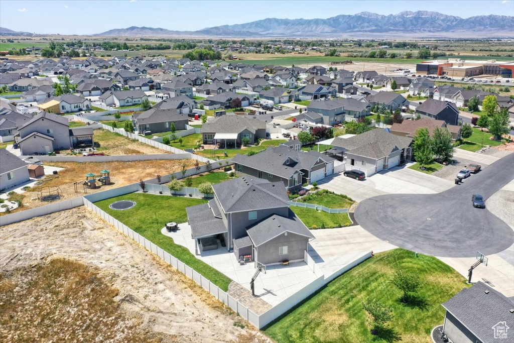 Aerial perspective of suburban area with a mountainous background