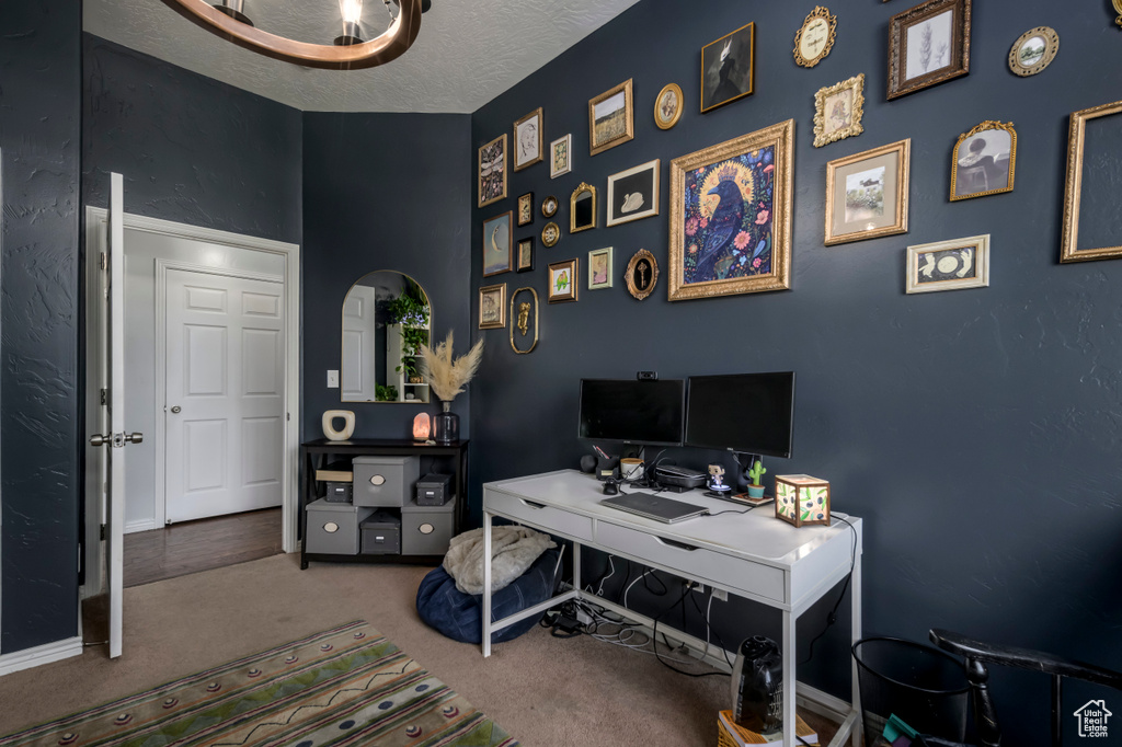 Home office with carpet and a textured ceiling