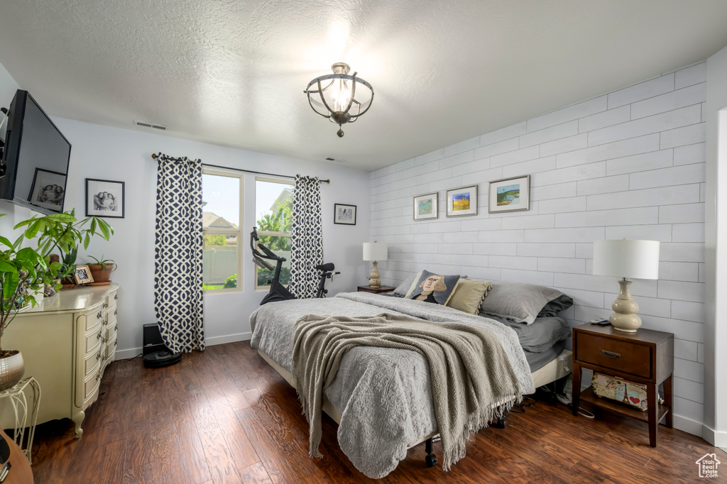 Bedroom featuring dark wood-style flooring
