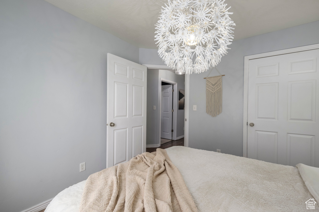 Bedroom featuring a chandelier and baseboards