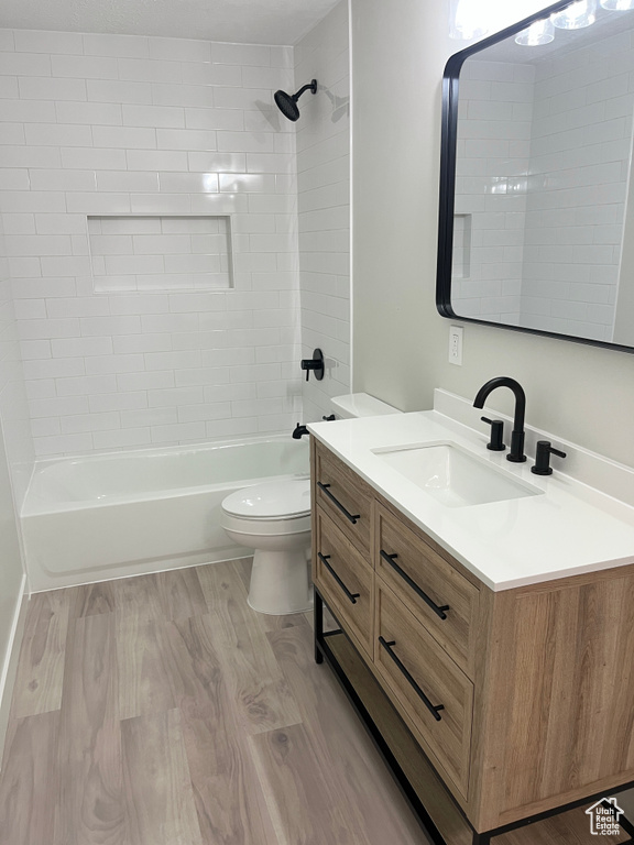 Full bathroom featuring vanity, bathtub / shower combination, and wood finished floors