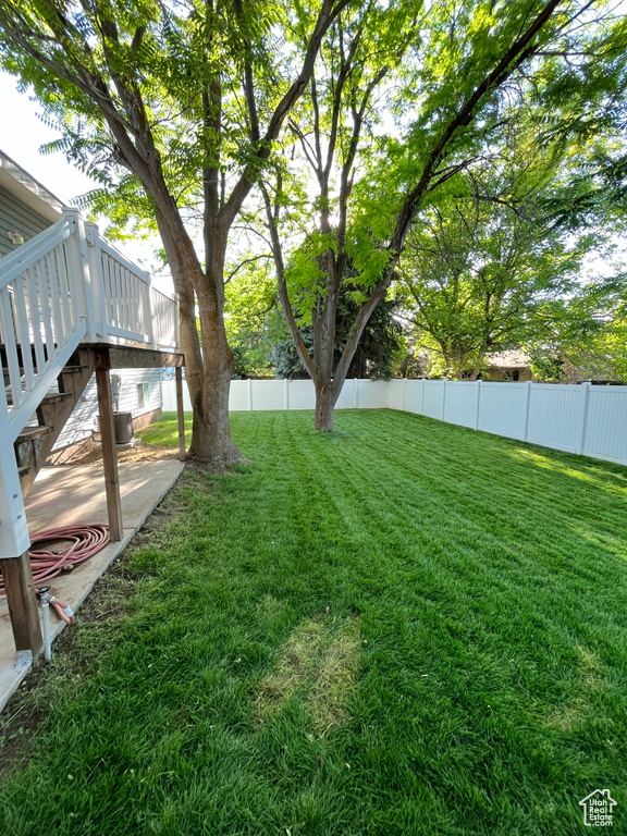 View of yard with a deck and stairway