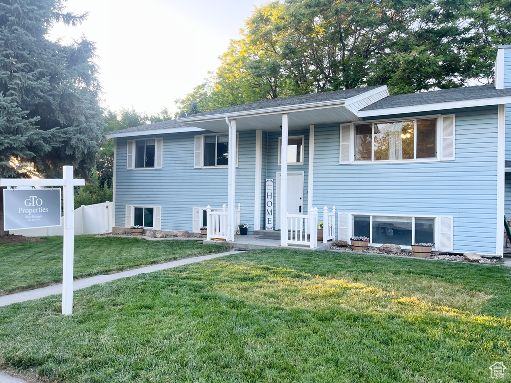 Bi-level home featuring a porch and a chimney