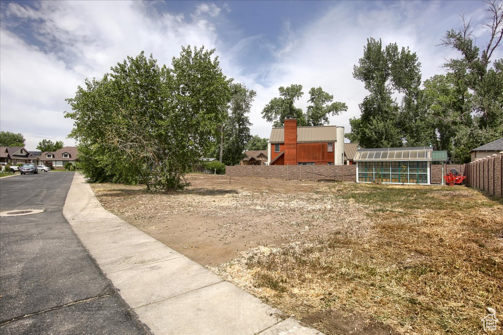 View of yard with a greenhouse and an outdoor structure