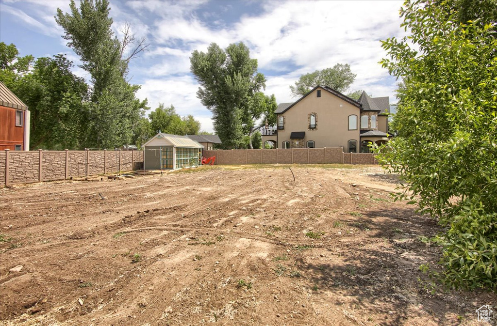 Fenced backyard featuring an exterior structure and an outdoor structure