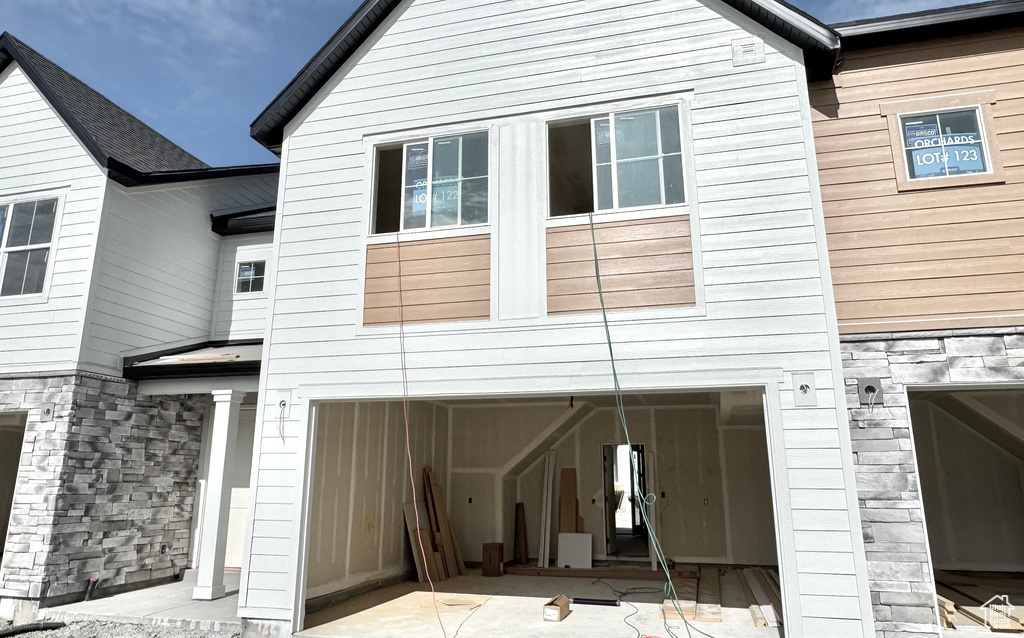 Rear view of property featuring an attached garage