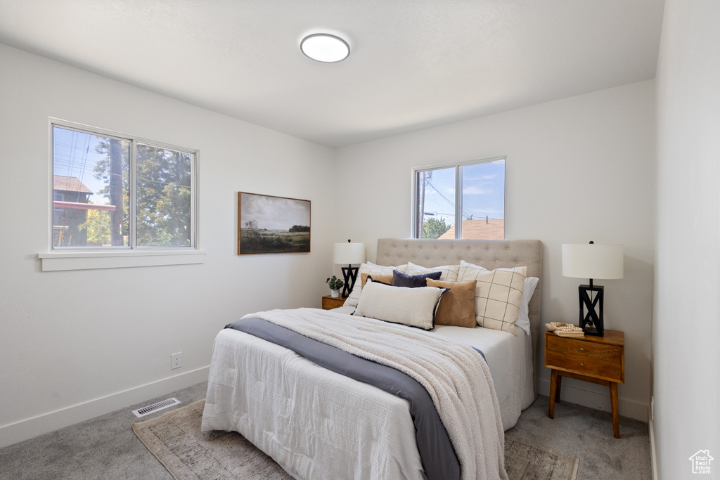 Bedroom with light carpet