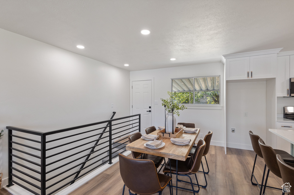 Dining area featuring recessed lighting and light wood-style flooring