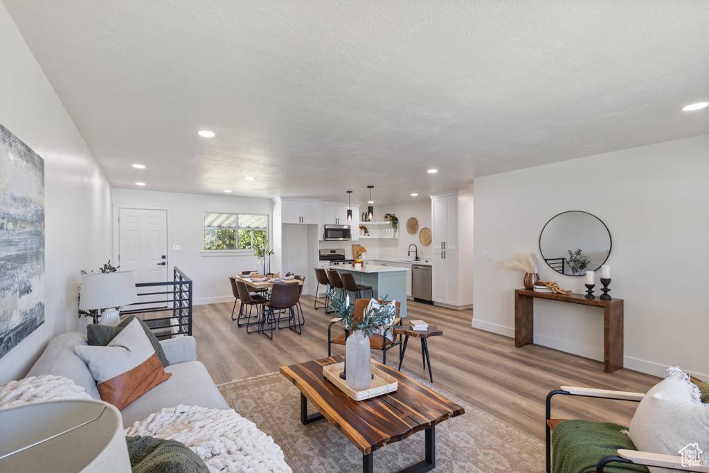 Living room featuring light wood finished floors and recessed lighting