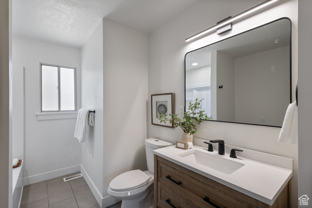 Bathroom featuring vanity and tile patterned flooring