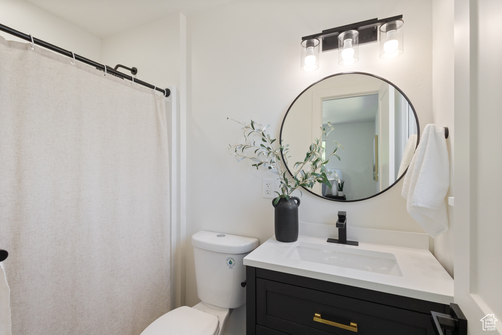 Bathroom with vanity and curtained shower