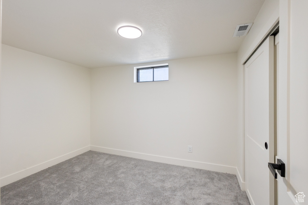 Below grade area featuring light colored carpet