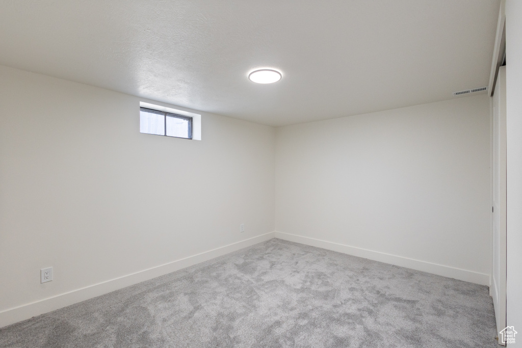 Basement with carpet and baseboards