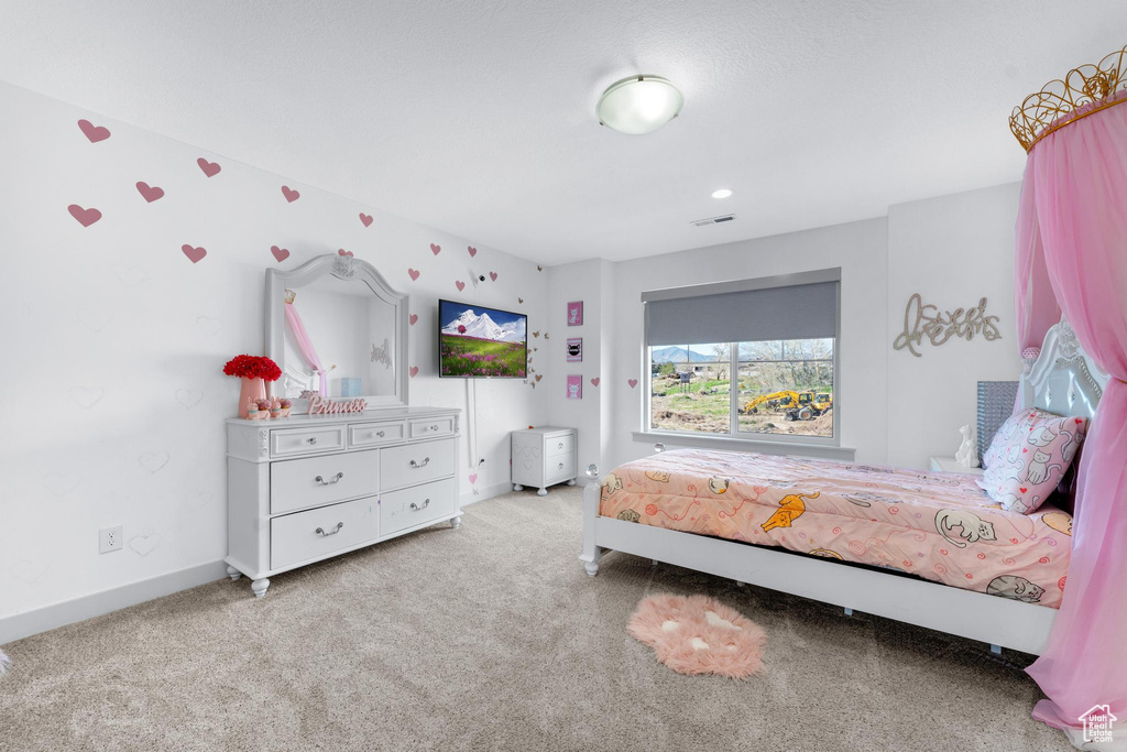 Bedroom featuring carpet and baseboards