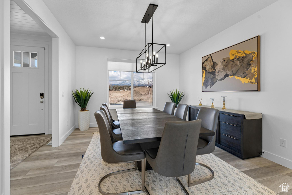 Dining room with a chandelier, light wood-style floors, and recessed lighting