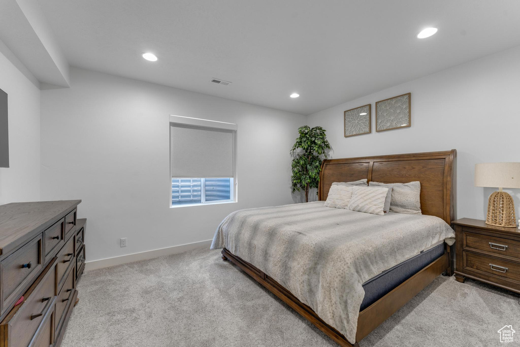Bedroom featuring light carpet and recessed lighting