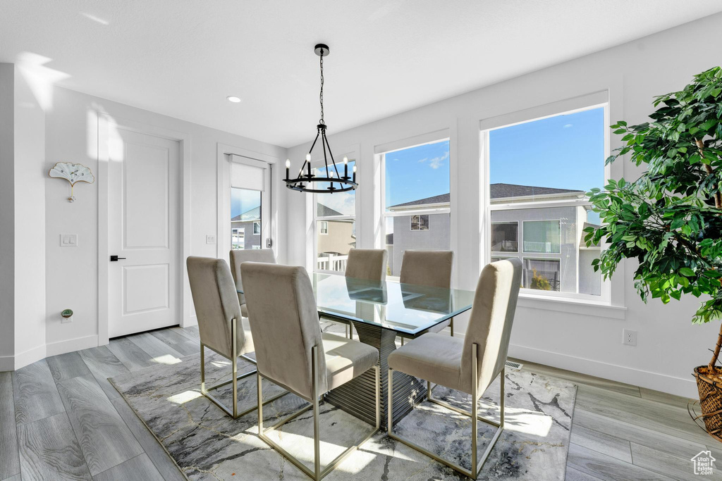 Dining space with a chandelier, light wood-type flooring, and recessed lighting