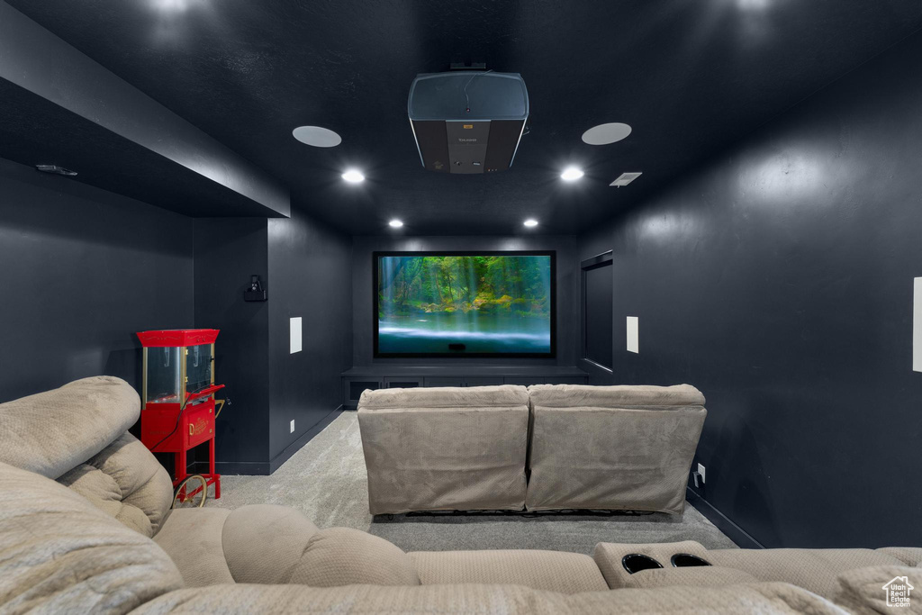 Carpeted cinema room with baseboards and recessed lighting