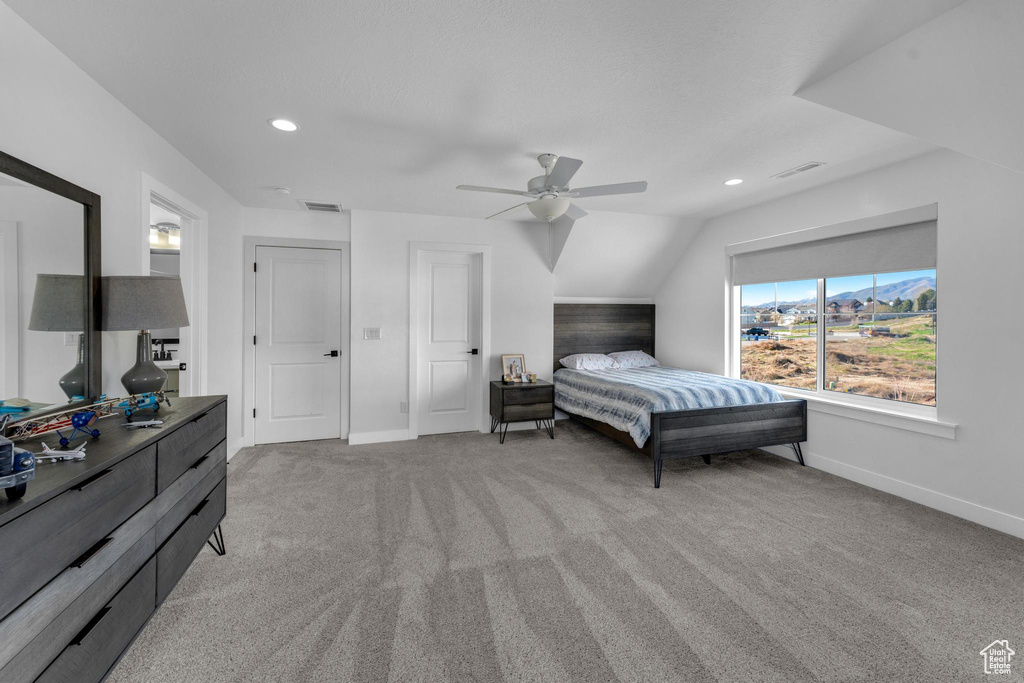 Bedroom with light carpet, recessed lighting, vaulted ceiling, and ceiling fan