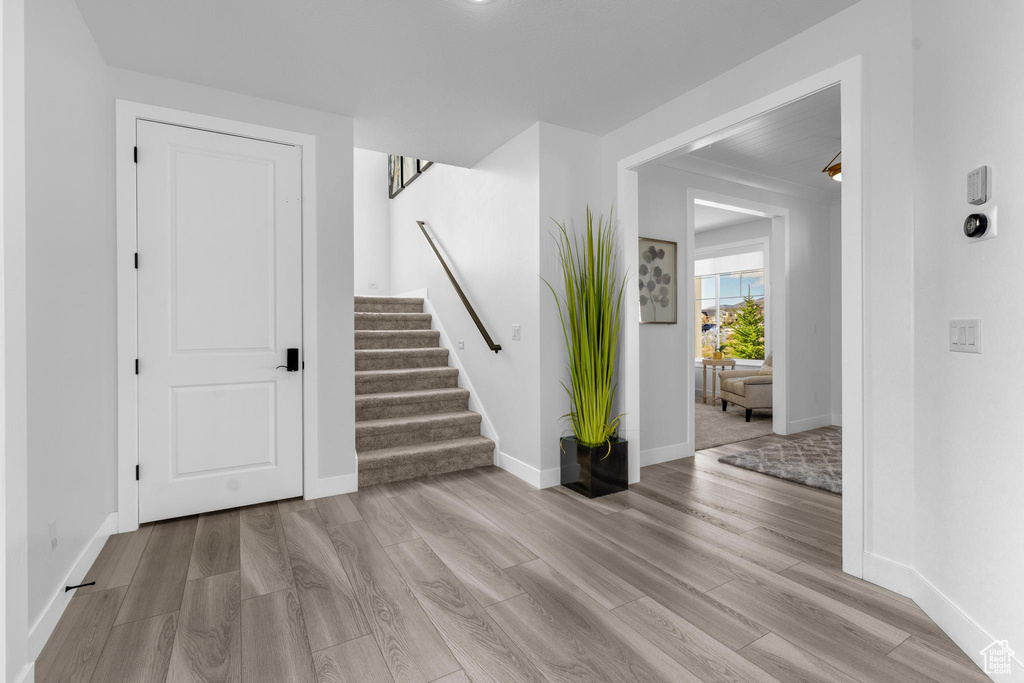 Entrance foyer featuring stairway and wood finished floors
