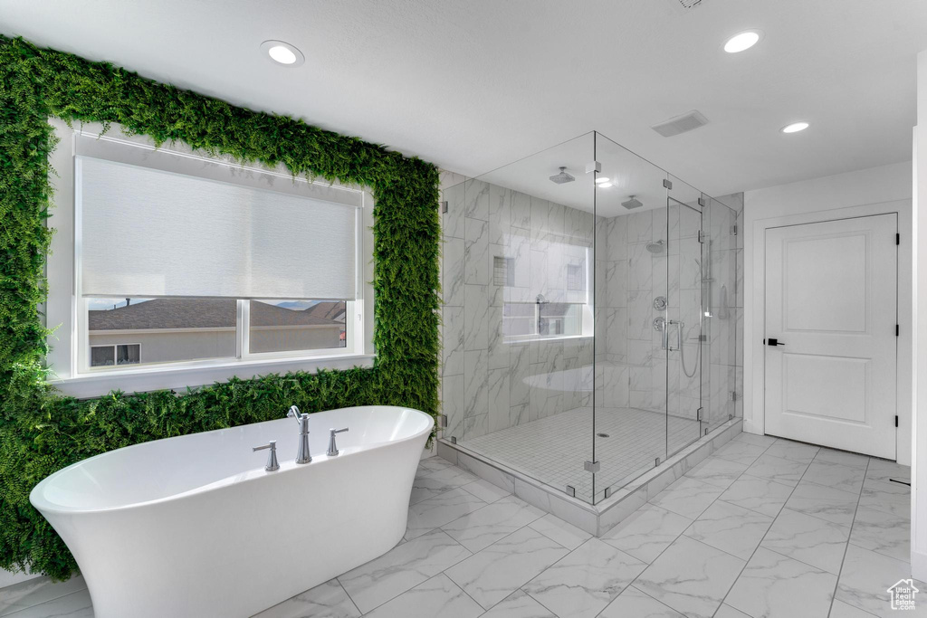 Full bathroom with a marble finish shower, a freestanding bath, recessed lighting, and marble finish flooring