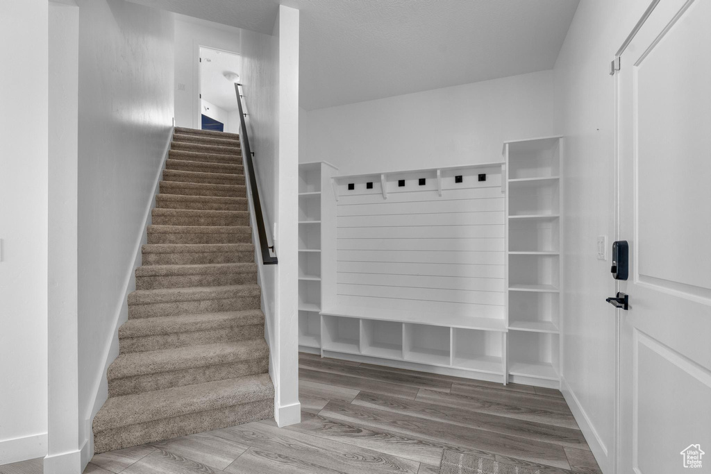 Mudroom with wood finished floors and baseboards