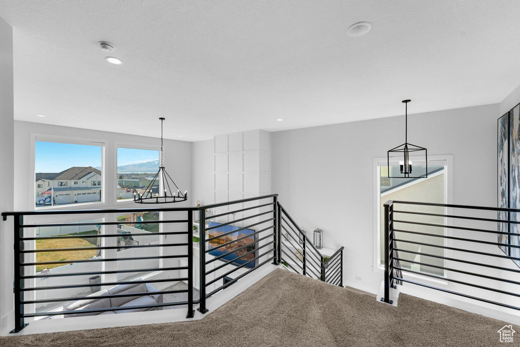 Stairs with a chandelier, carpet, and recessed lighting