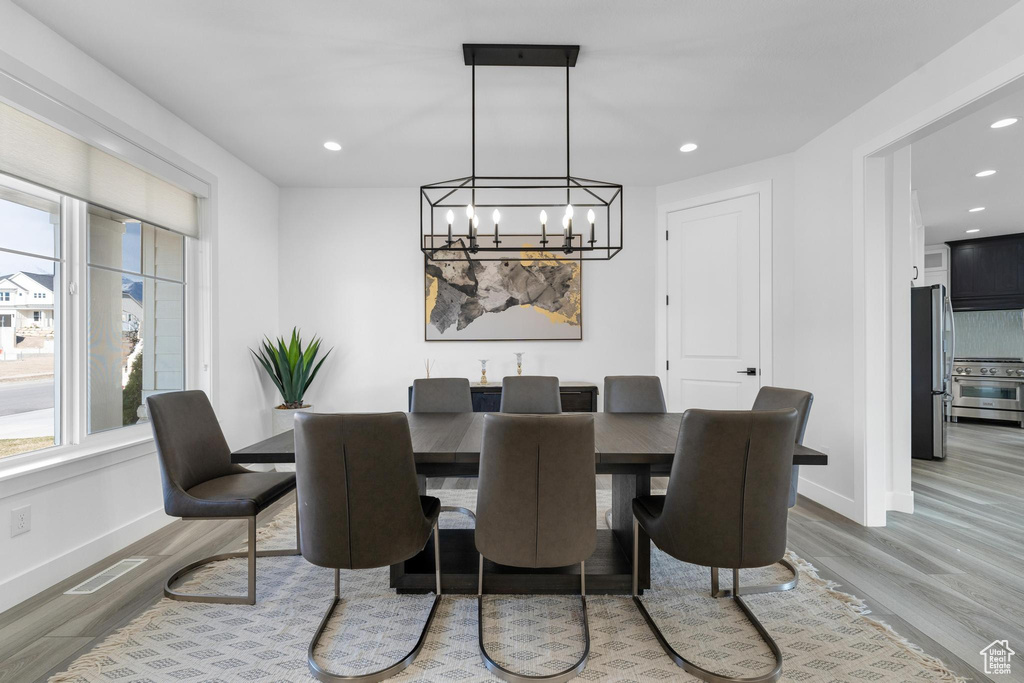Dining area featuring wood finished floors, a chandelier, and recessed lighting