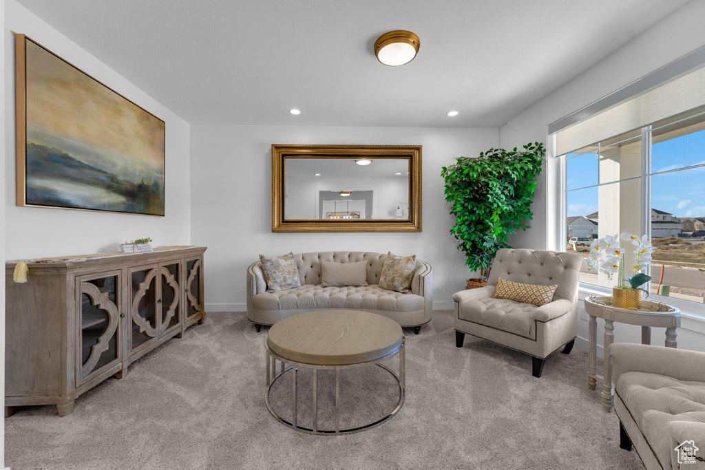 Living area with carpet floors and recessed lighting