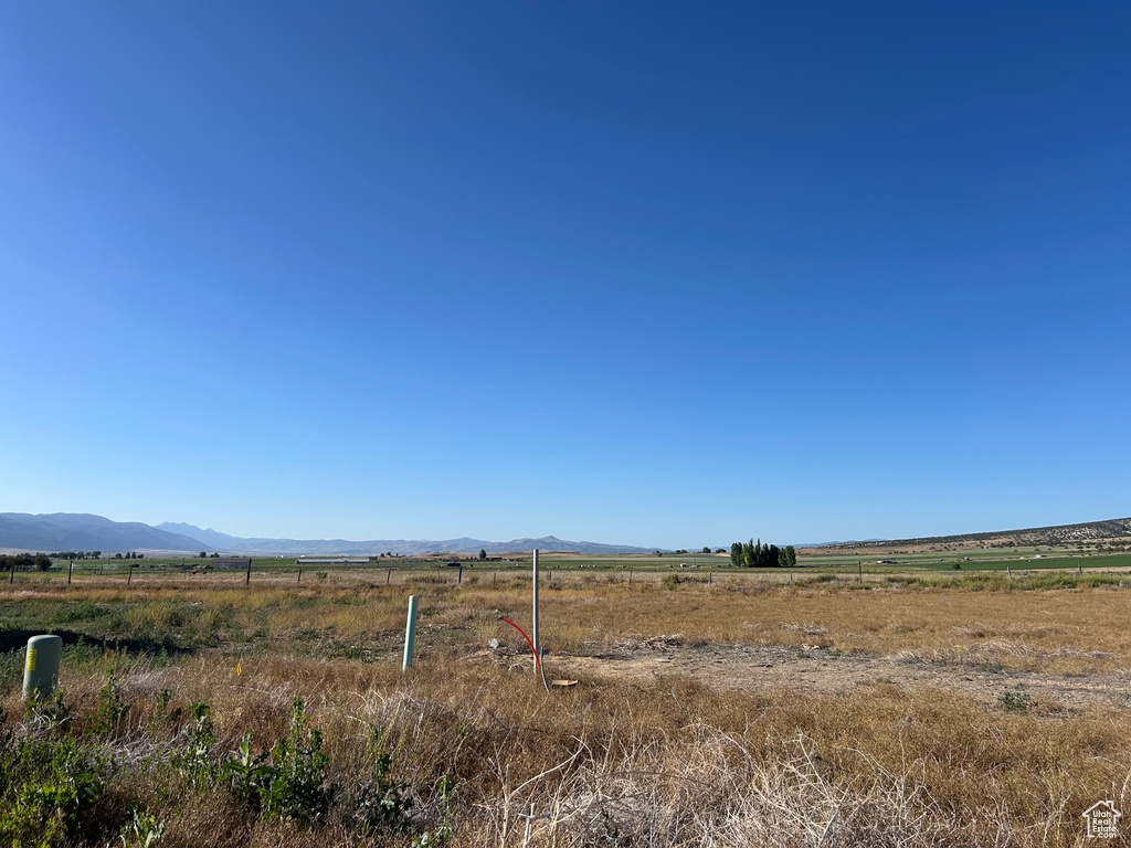 View of yard featuring a rural view and a mountain view
