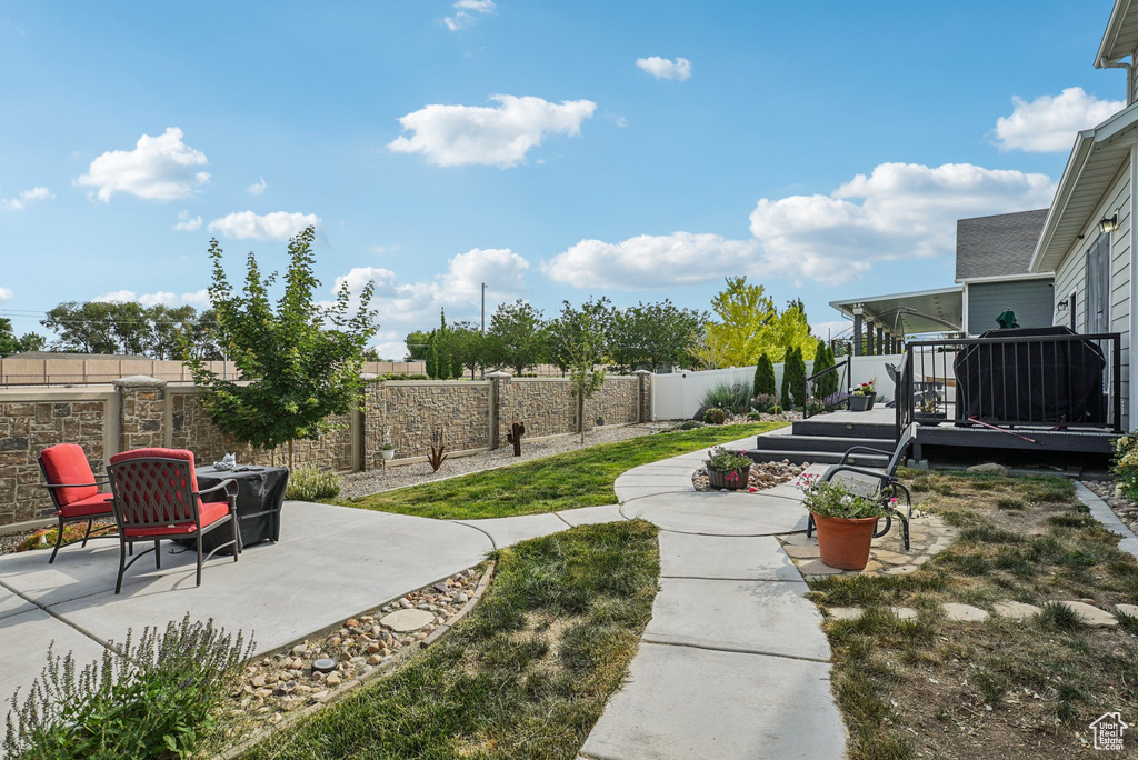 Fenced backyard with a patio and a deck