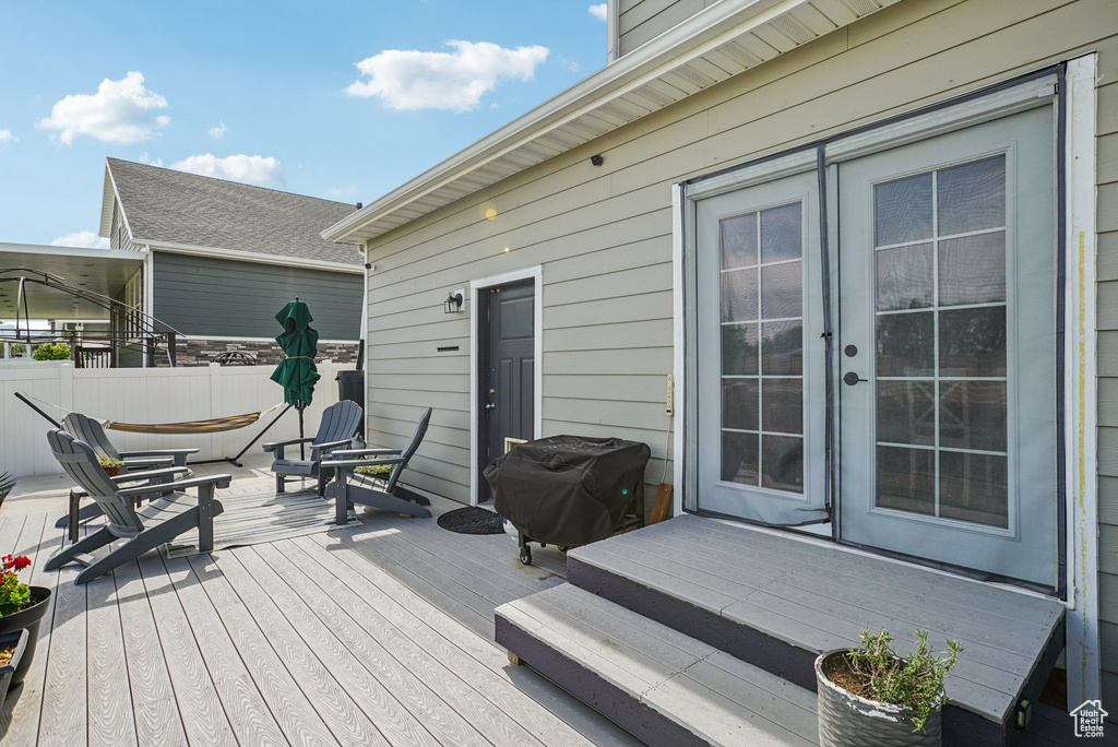 Wooden terrace featuring area for grilling