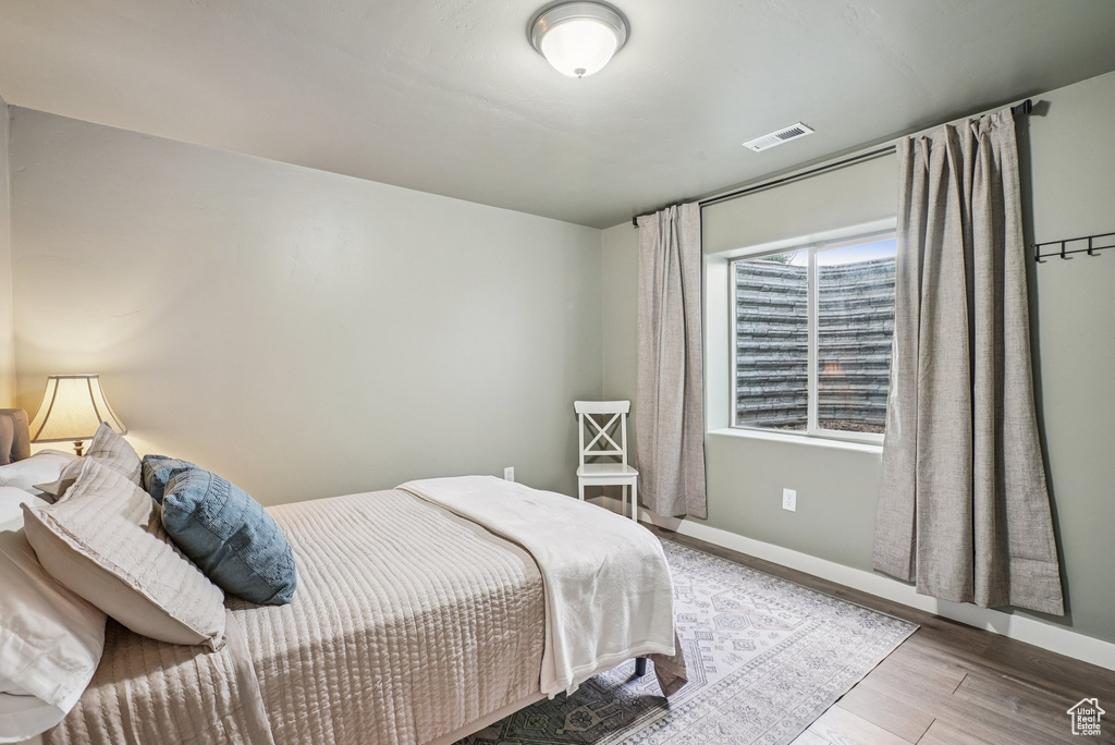 Bedroom featuring wood finished floors and baseboards