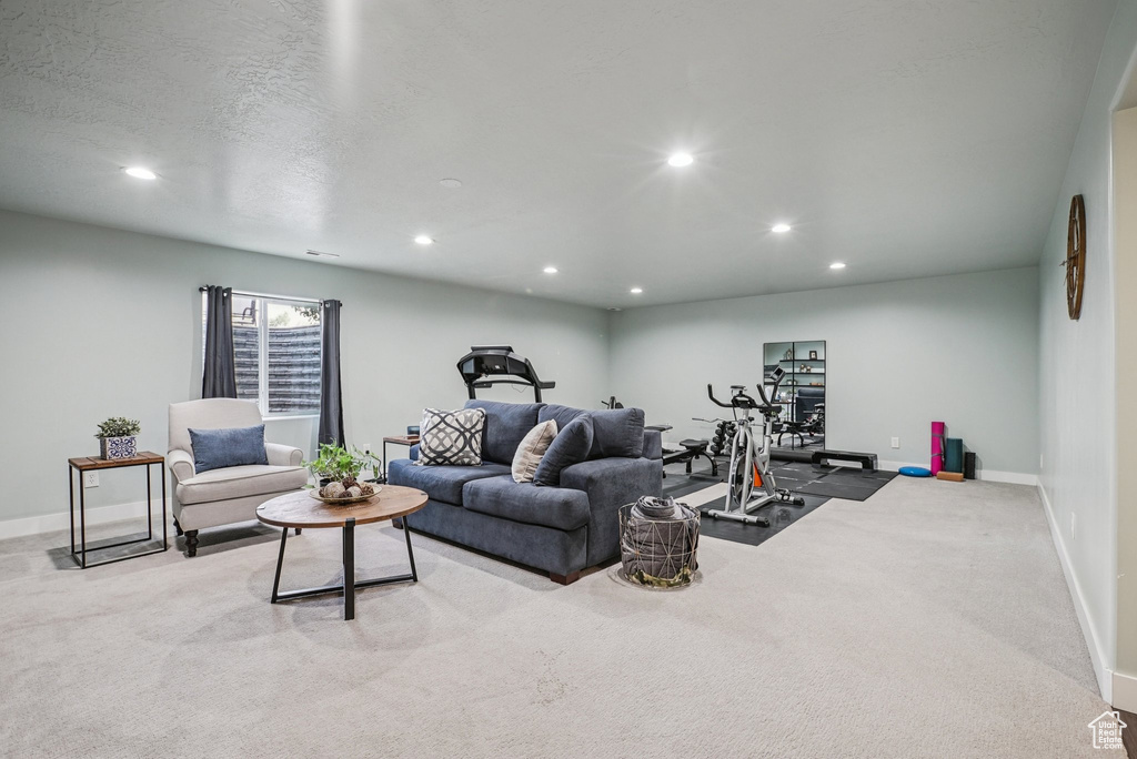 Carpeted living area featuring recessed lighting