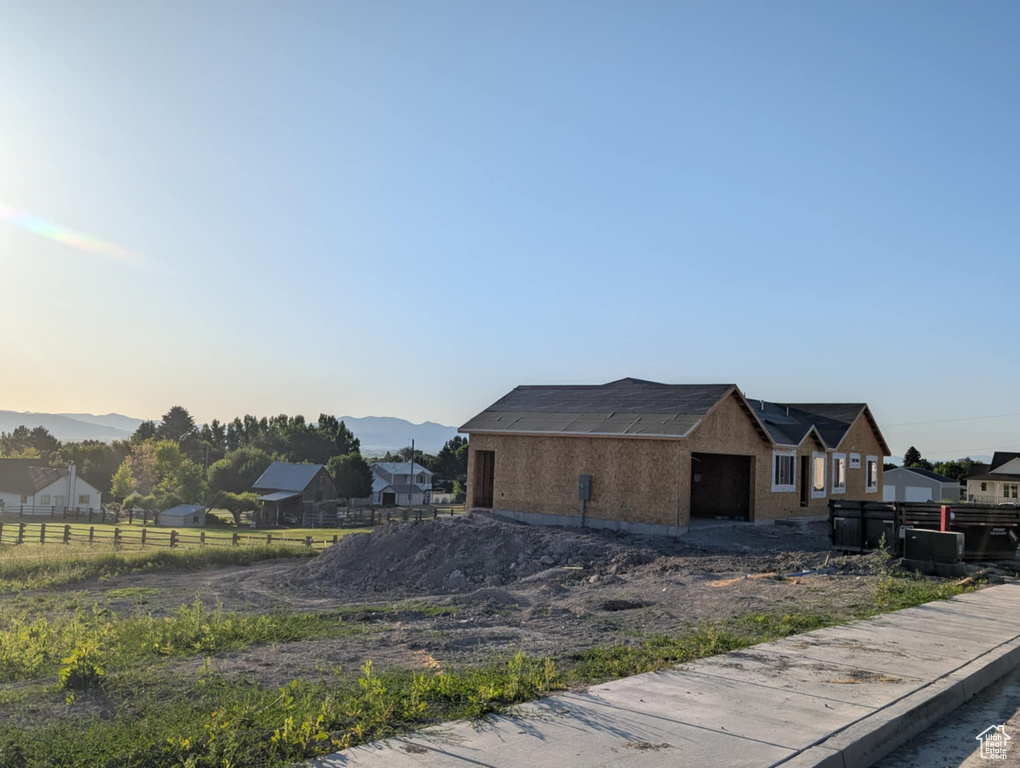 View of property exterior with a garage and a mountain view