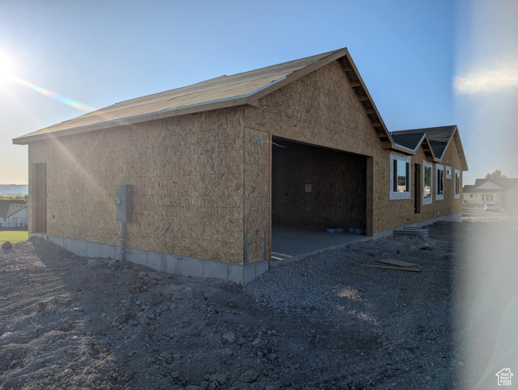 View of side of property featuring an attached garage