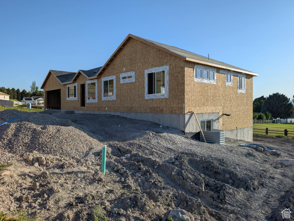 Rear view of property with a garage
