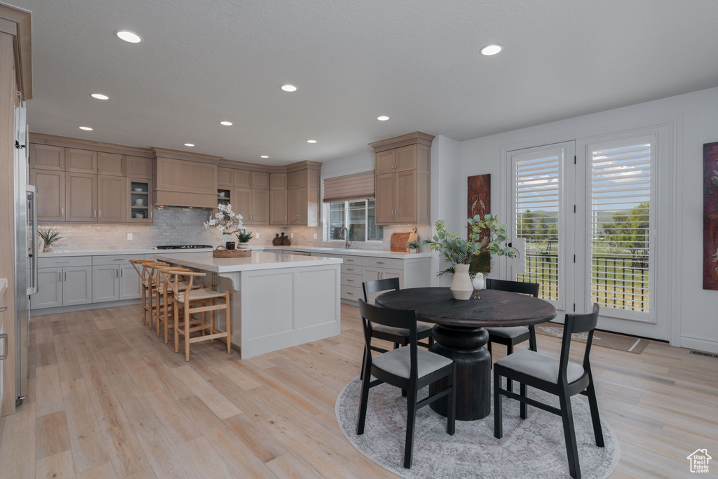 Dining space featuring plenty of natural light, light wood finished floors, and recessed lighting