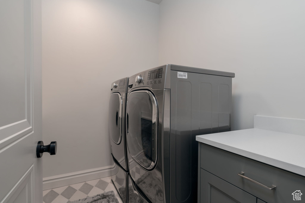 Laundry area with independent washer and dryer and cabinet space