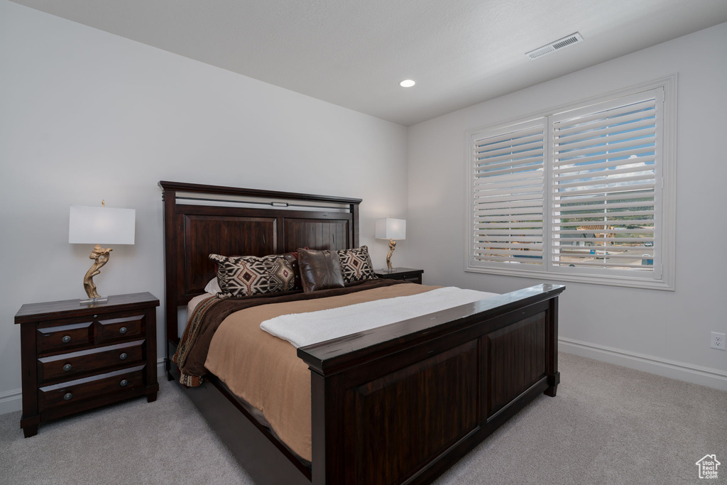 Bedroom featuring light carpet and recessed lighting